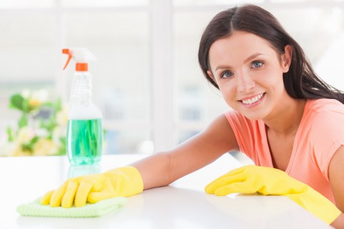 Person blotting a fresh stain on fabric during stain removal